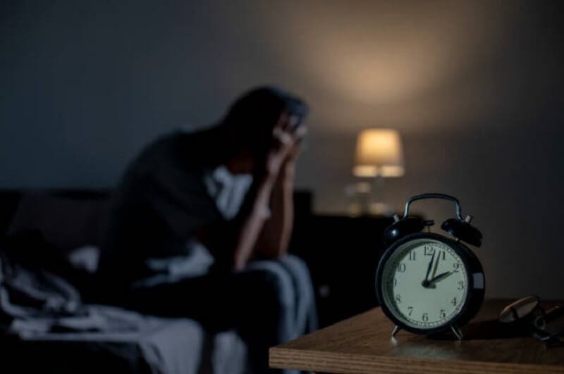 Depressed man sitting in the bedroom