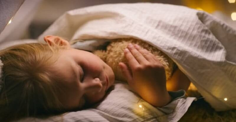 Little girl sleeping with her teddy bear