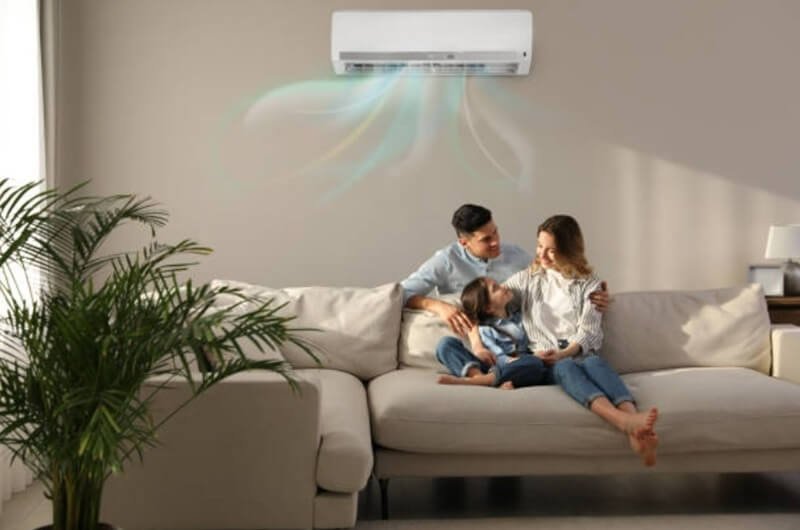 A family enjoying the cooling facts in an air conditioning living room